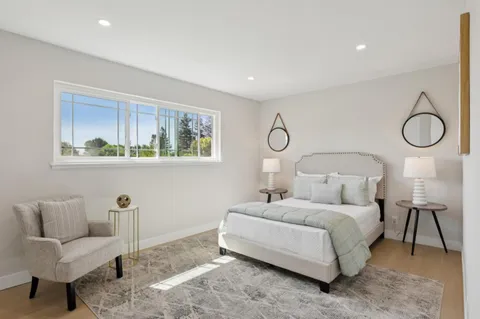 a bedroom with bed and a couch