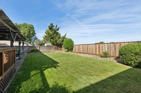 a view of a house with a yard and sitting area