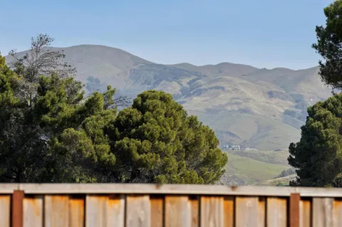 a view of a wooden fence and a mountain view