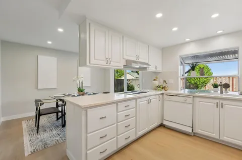 a kitchen with cabinets appliances and a window