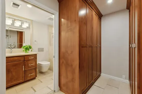 a bathroom with a toilet a sink and vanity