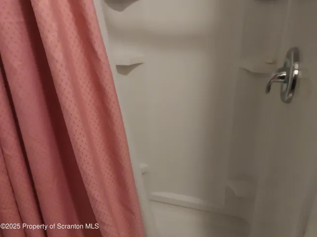 a storage room with water heater and racks