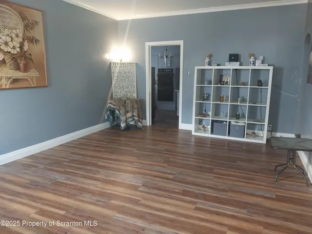 a view of room with furniture and wooden floor