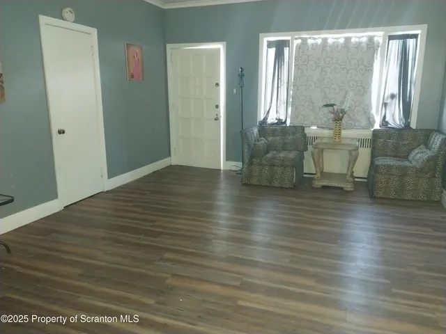 a view of a room with wooden floor