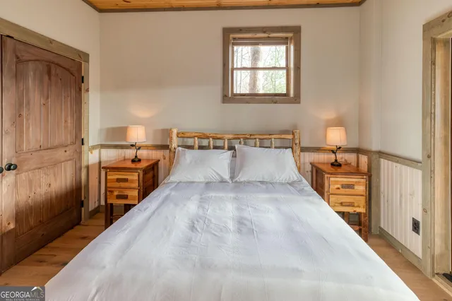 a bedroom with furniture and large windows