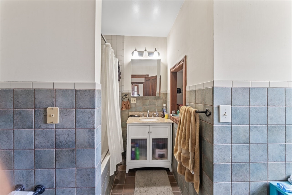 388 Arborway Boston, MA 02130 - Photo 17 of 29 a view of a bathroom with a sink and mirror