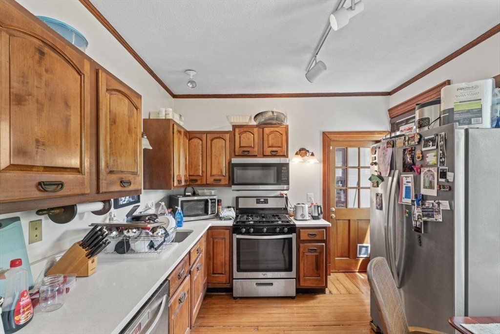388 Arborway Boston, MA 02130 - Photo 19 of 29 a kitchen with stainless steel appliances a stove a sink and a refrigerator
