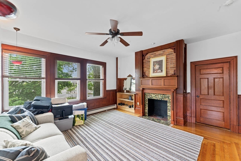 388 Arborway Boston, MA 02130 - Photo 5 of 29 a living room with furniture windows and a fireplace