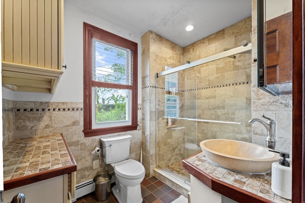 388 Arborway Boston, MA 02130 - Photo 8 of 29 a bathroom with a sink a toilet and shower