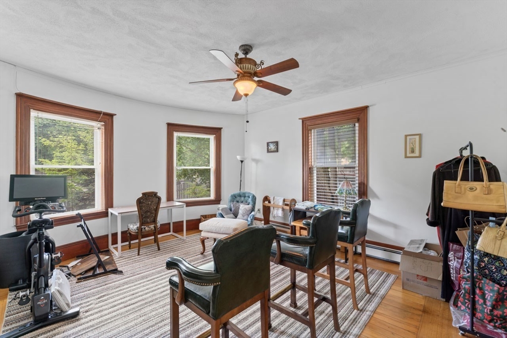 388 Arborway Boston, MA 02130 - Photo 9 of 29 a living room with fireplace furniture and a window