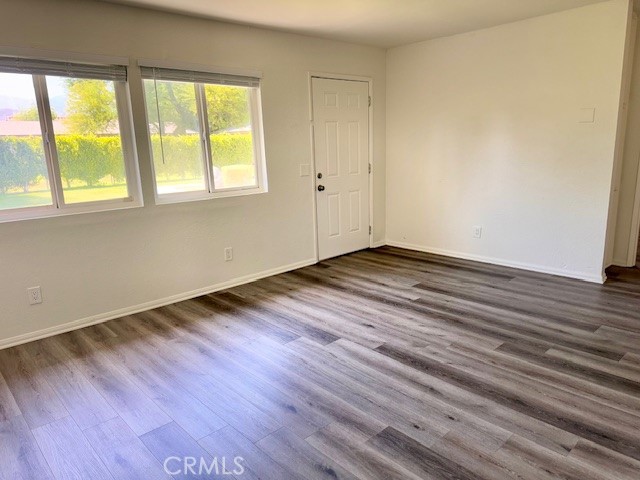 73740 Santa Rosa Way, Unit E Palm Desert, CA 92260 - Photo 15 of 15 a view of an empty room with wooden floor and a window