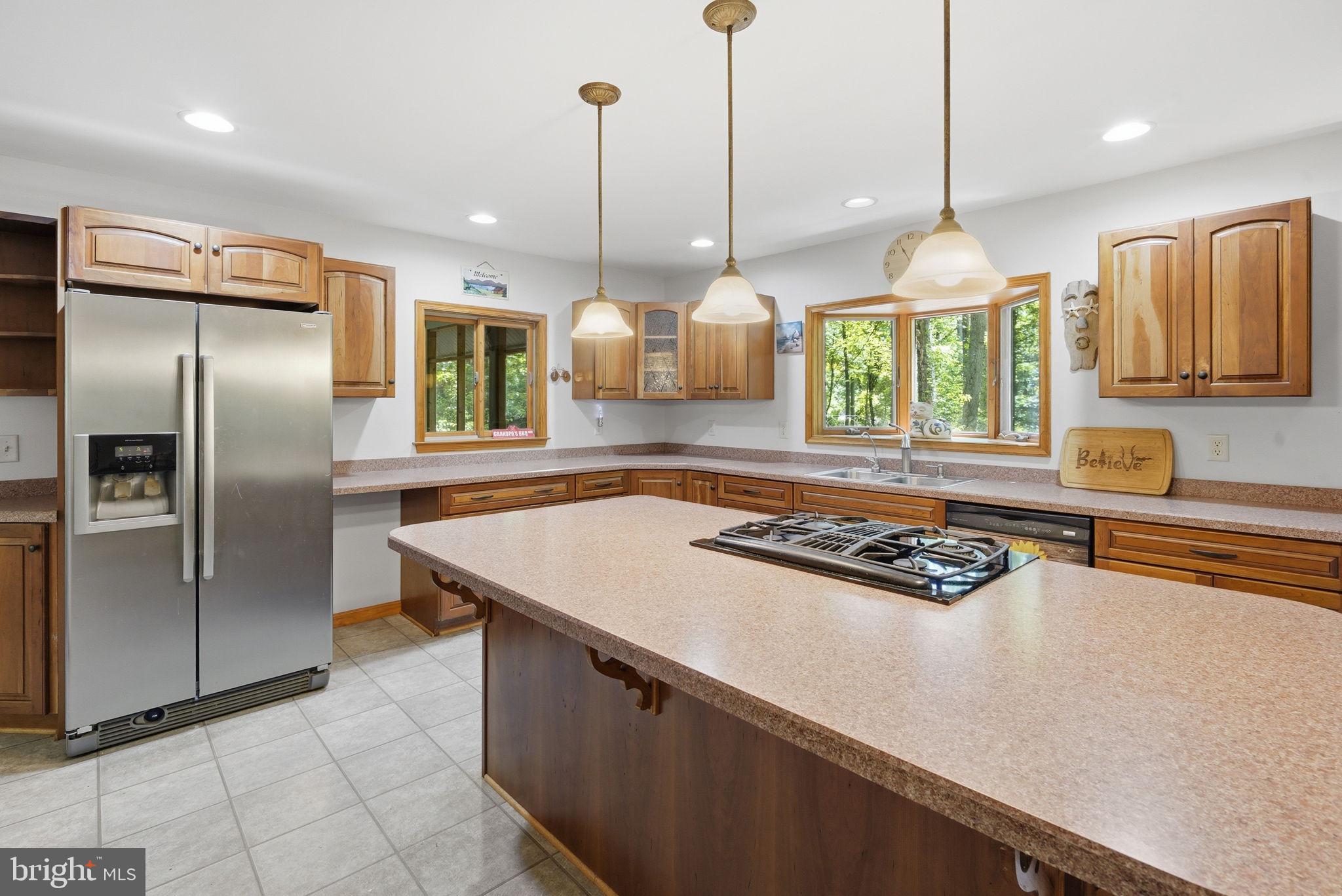 22300 Frazier Road Rock Hall, MD 21661 - Photo 6 of 38 a kitchen with stainless steel appliances granite countertop a sink a stove and a refrigerator