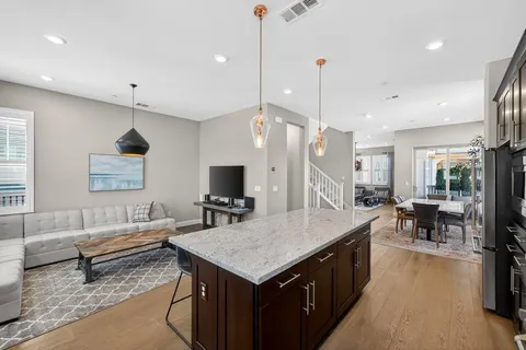 a living room with a table chairs and a flat screen tv