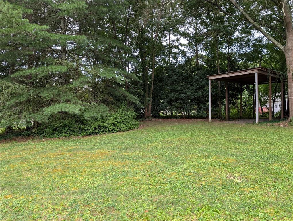 402 Pheasant Run Rome, GA 30161 - Photo 7 of 74 a view of a backyard with a garden