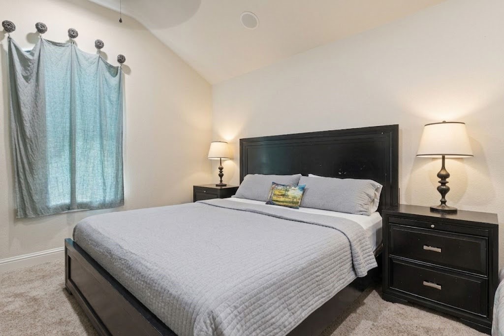 3818 Waterbend Cove Spring, TX 77386 - Photo 26 of 44 a bedroom with a bed and a mirror