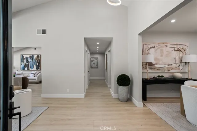 a view of living room with furniture and wooden floor