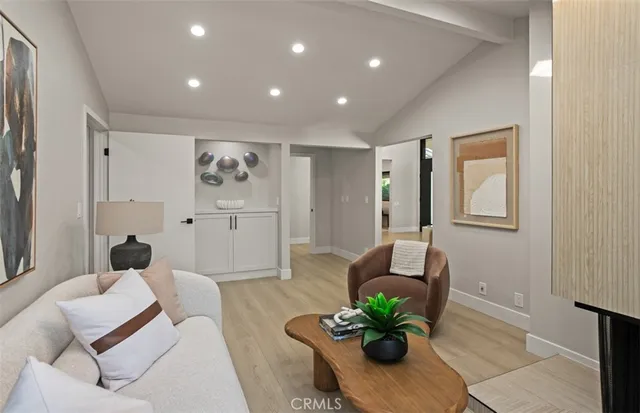 a living room with furniture and a potted plant