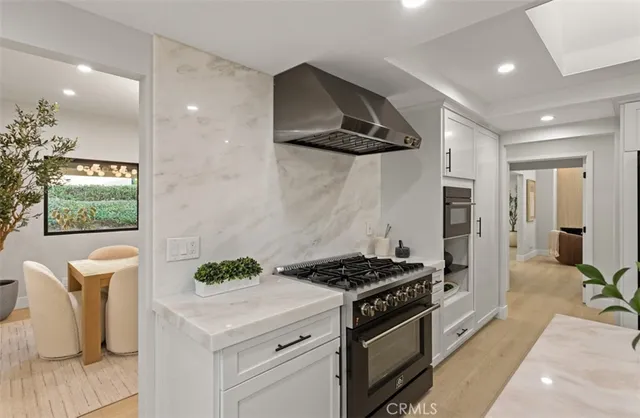 a kitchen with stainless steel appliances granite countertop a stove a sink and a refrigerator