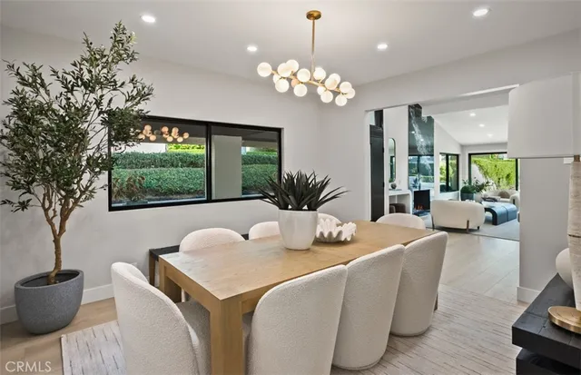 a dining room with furniture and a large window