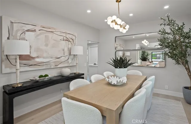 a view of a dining room with furniture and chandelier