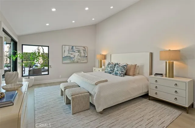 a bedroom with a large bed and a large window