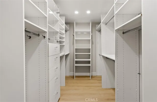 a view of walk in closet with empty racks