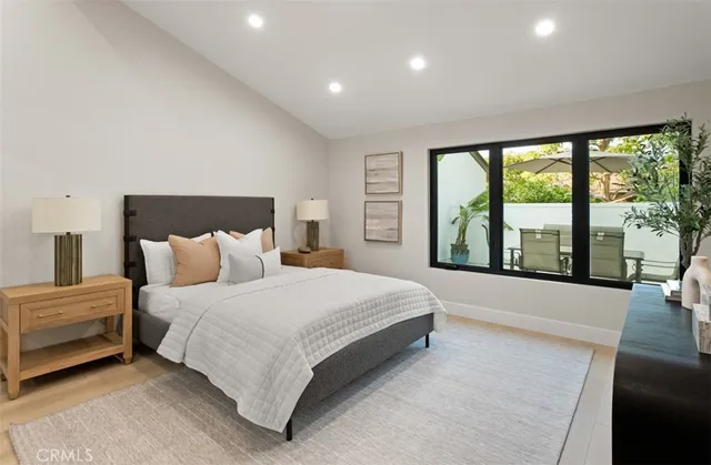 a spacious bedroom with a large bed and large windows