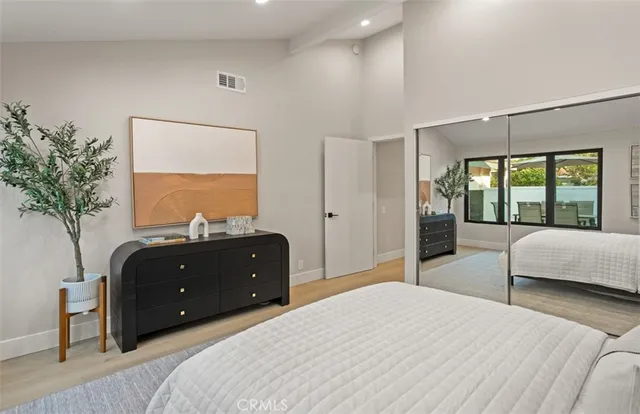 a bedroom with a bed and a couch