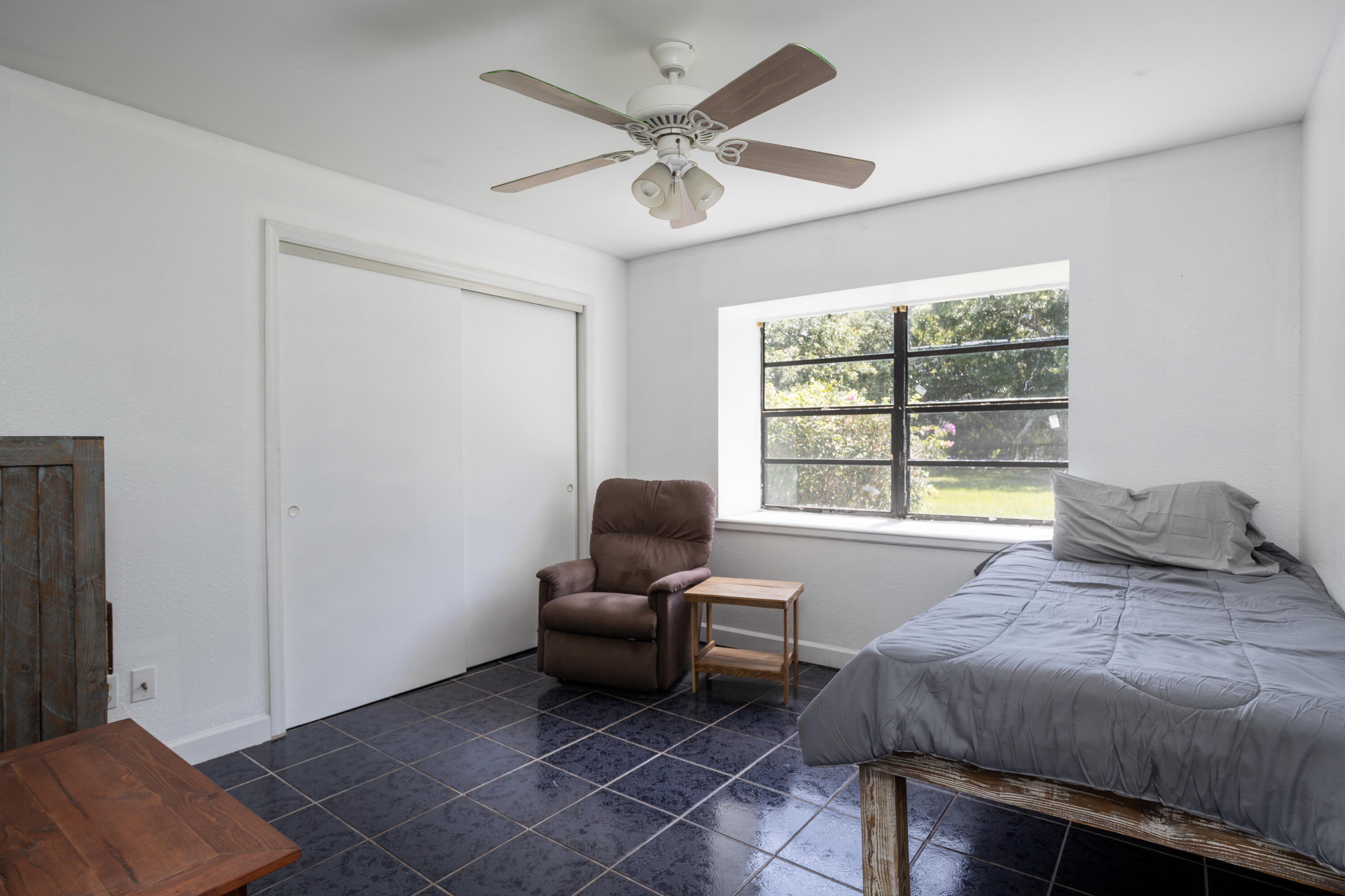 1280 Corey Road Malabar, FL 32950 - Photo 26 of 56 a bedroom with a bed and a window