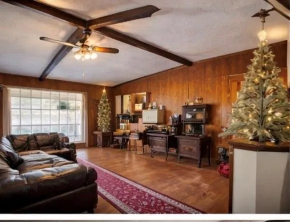a living room with lots of furniture and a large window