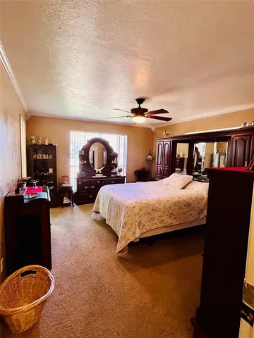 a bed sitting in a bedroom next to a bookshelf