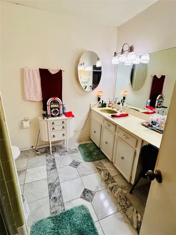 a living room with a sink and a mirror
