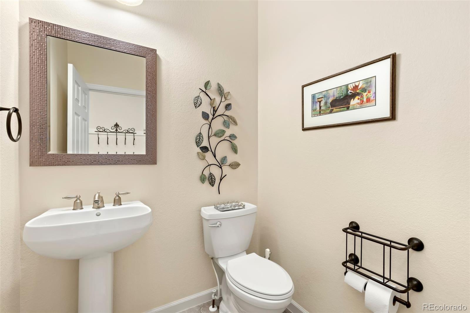 4945 Bierstadt Loop Broomfield, CO 80023 - Photo 13 of 33 a bathroom with a toilet sink and mirror