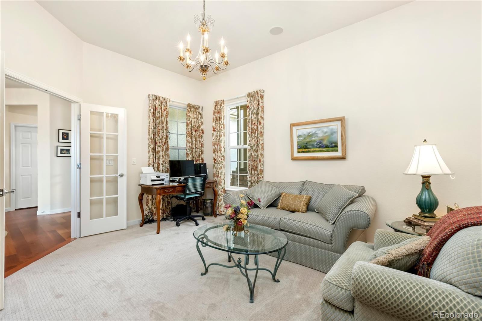 4945 Bierstadt Loop Broomfield, CO 80023 - Photo 14 of 33 a living room with furniture a lamp and a chandelier