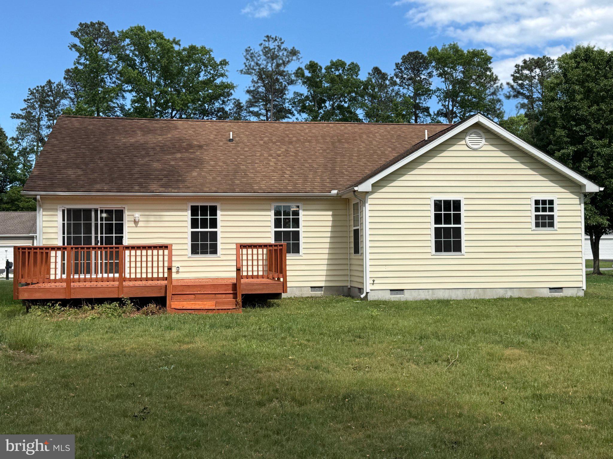 30952 Sandy Ridge Drive Lewes, DE 19958 - Photo 17 of 17 a front view of a house with a garden and deck