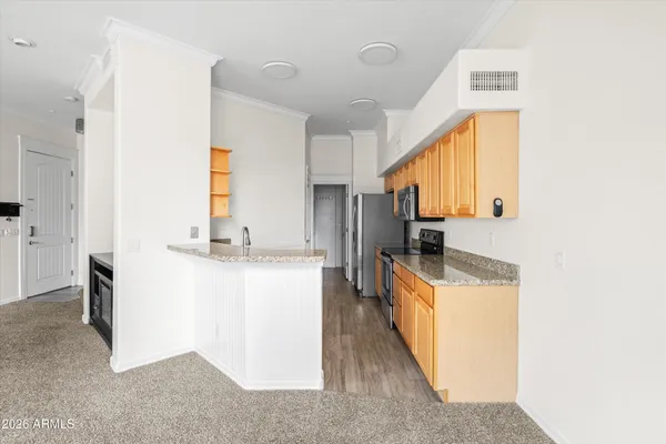 a kitchen with a sink stove and a refrigerator