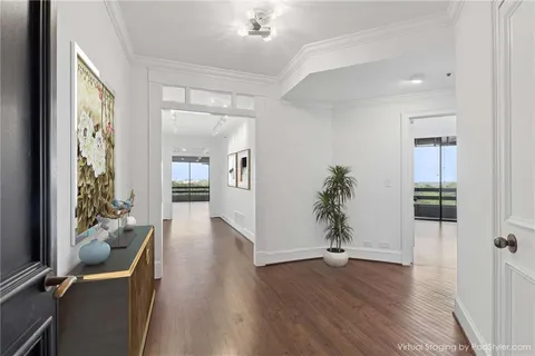 a living room with furniture kitchen view and a flat screen tv