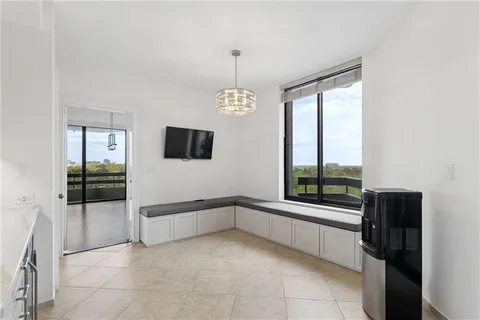 a room with gym equipment and large windows