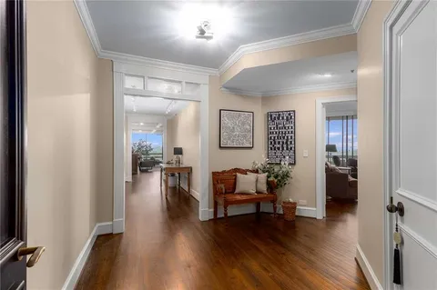 a living room with furniture and a wooden floor
