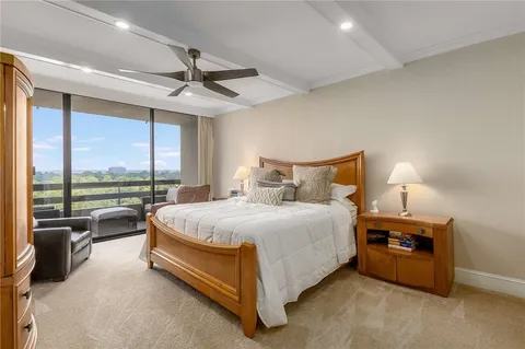 a spacious bedroom with a bed and a large window