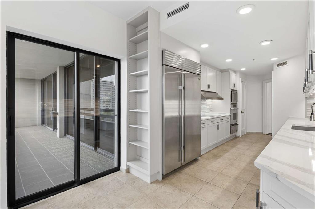 2660 Peachtree Road Northwest, Unit 13F Atlanta, GA 30305 - Photo 22 of 56 a large bathroom with a glass door shower and sink