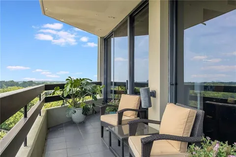 a balcony with couple of chairs and couch