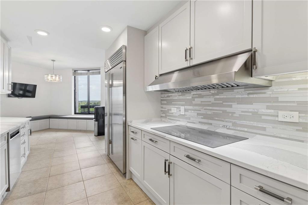 2660 Peachtree Road Northwest, Unit 13F Atlanta, GA 30305 - Photo 26 of 56 a kitchen with a sink stainless steel appliances and cabinets