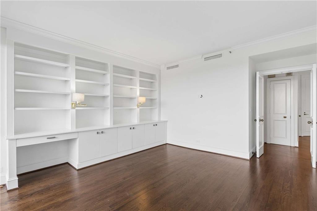 2660 Peachtree Road Northwest, Unit 13F Atlanta, GA 30305 - Photo 28 of 56 a view of an empty room with wooden floor and closet