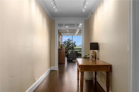 a view of a hallway with workspace and a window