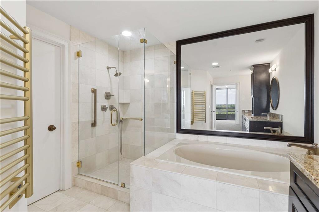 2660 Peachtree Road Northwest, Unit 13F Atlanta, GA 30305 - Photo 32 of 56 a spacious bathroom with a tub shower and sink