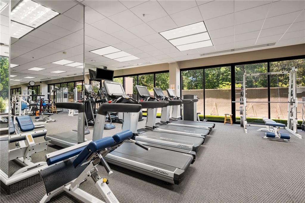 2660 Peachtree Road Northwest, Unit 13F Atlanta, GA 30305 - Photo 44 of 56 a room with gym equipment and large windows