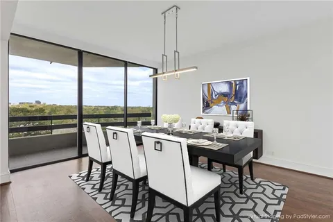 a dining room with furniture a chandelier and wooden floor