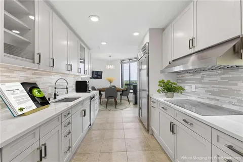 a view of an empty room with wooden floor and glass door