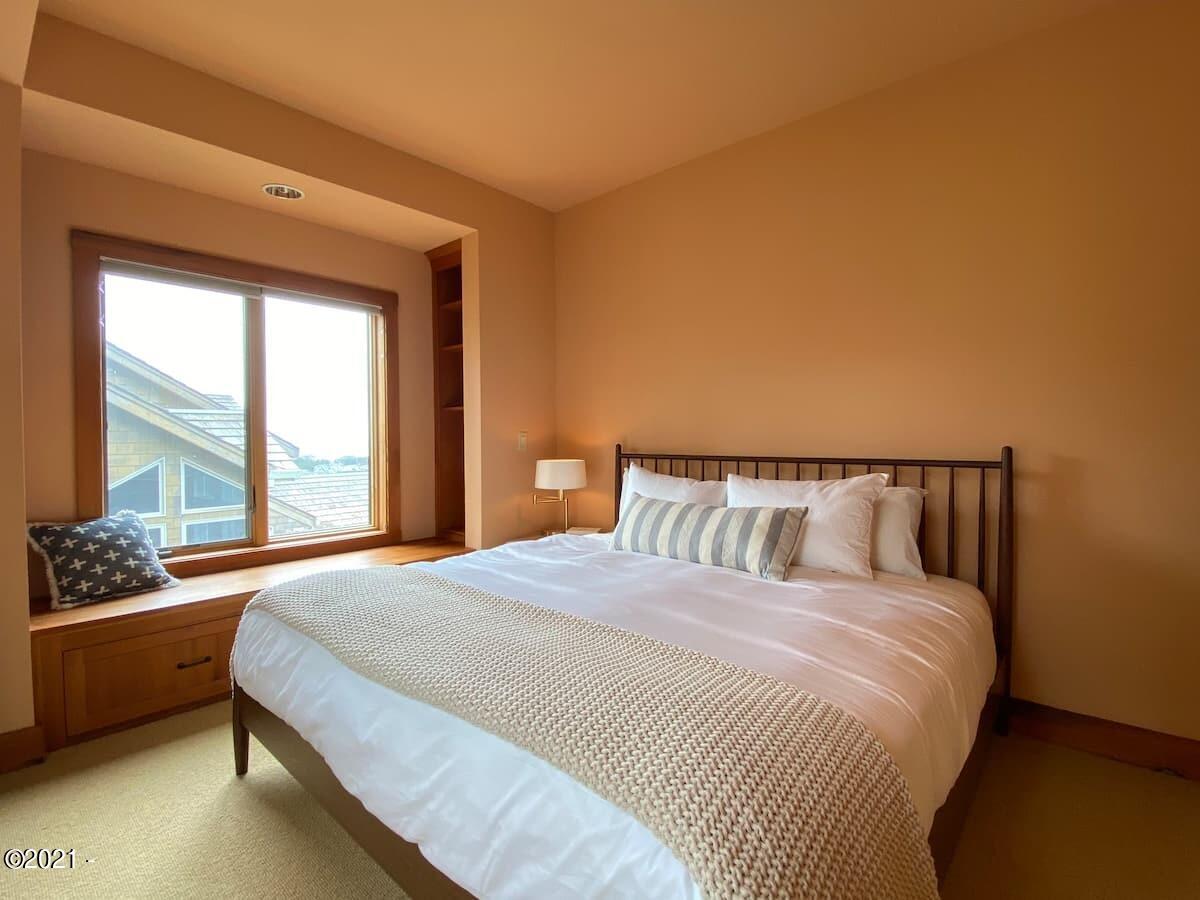 6355 Nestucca Ridge Road Pacific City, OR 97135 - Photo 12 of 20 a large bed sitting in a bedroom next to a window